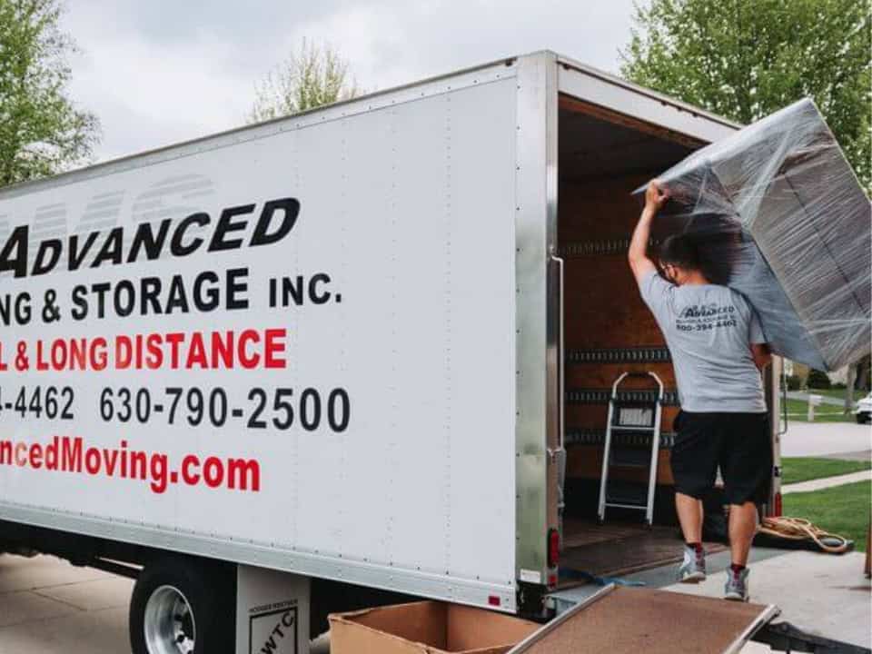 moving truck with a person loading furniture for long distance move.